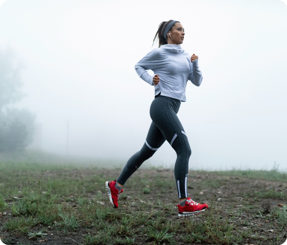 Runner on a foggy trail framed by scrolling text